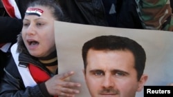 Supporters of Syria's President Assad attend a rally in Damascus on January 20.