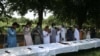 Former Taliban militants surrender their weapons during a reconciliation ceremony in Jalalabad on July 27.
