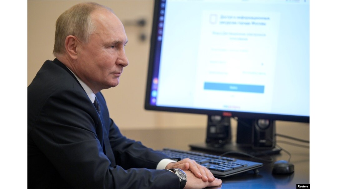 Russian President Vladimir Putin votes online at his residence outside Moscow.