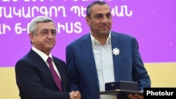 Armenia - President Serzh Sarkisian (L) awards a state medal to businessman Samvel Aleksanian in Yerevan, 26 September 2015.