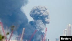 Smoke rises in the sky after blasts were heard in the Bahrani capital, Manama, on February 28.