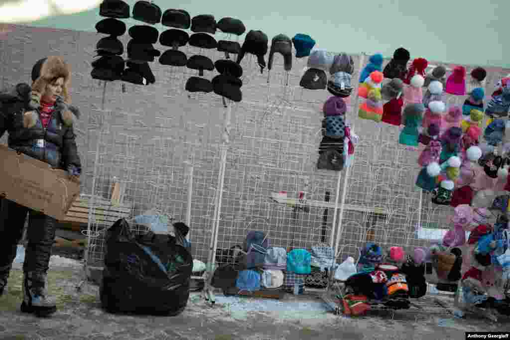 A vendor sells Chinese-manufactured goods at a street market.