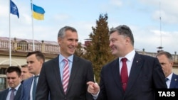 Генэральны сакратар НАТО Енс Столтэнбэрг і прэзыдэнт Украіны Пятро Парашэнка (зьлева направа на першым пляне) падчас сумесных вучэньняў Украіна-НАТО па ліквідацыі наступстваў надзвычайных сытуацыяў "Украіна-2015" на Яварыўскім палігоне, 21 верасьня 2015 году 