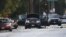 Law-enforcement officials investigate the Ford SUV vehicle that was the scene where suspects of the shooting at the Inland Regional Center were killed on December 3 in San Bernardino, California. 