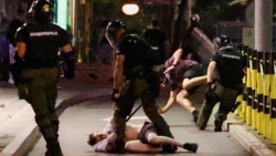 Serbian police officers detain demonstrators in Belgrade during an anti-government protest on June 28. 