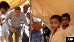 Richard Holbrooke, U.S. envoy for Afghanistan and Pakistan, enters a tent to meet a displaced family from the Swat and Buner district in Mardan, Pakistan, in June.