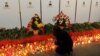 A girl places candles at an impromptu memorial to victims of the Minsk metro bombing, which killed 15 people last year. (file photo)