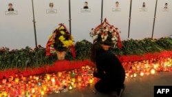 A girl places candles at an impromptu memorial to victims of the Minsk metro bombing, which killed 15 people last year. (file photo)