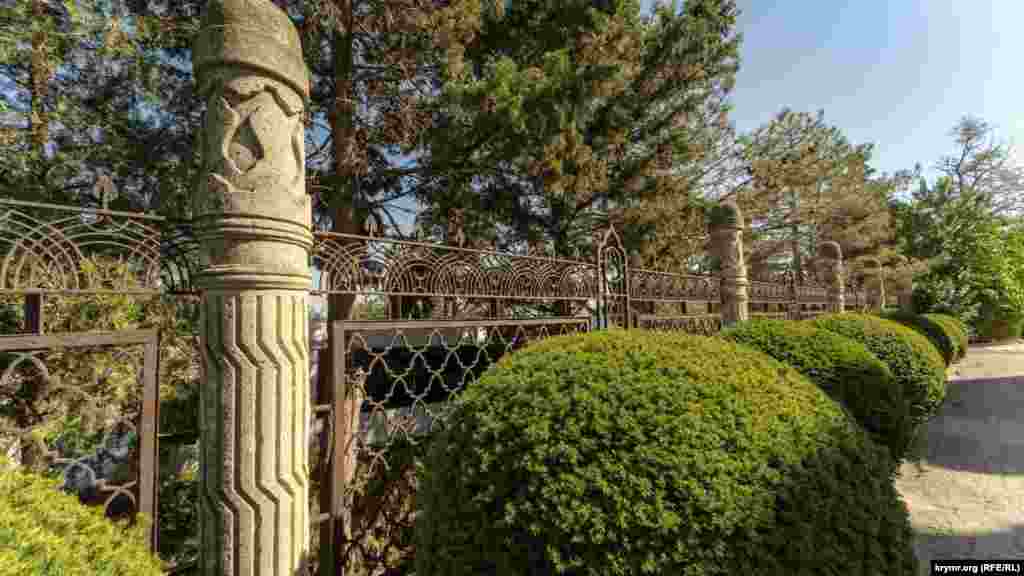 На ограде кованого забора можно разглядеть резные листья табака и растительный орнамент. Столбики забора изготовлены в форме огромных сигар