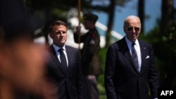 French President Emmanuel Macron (left) and U.S. President Joe Biden attend the 80th anniversary of the World War II D-Day landings in Normandy on June 6. 