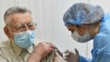 UKRAINE -- An elderly man receives a dose of the Oxford University/AstraZeneca vaccine against the coronavirus disease (COVID-19), which is produced in India and marketed as Covishield, at a local clinic in Lviv, March 24, 2021