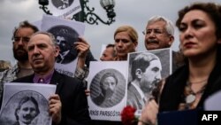 Rights activists hold placards picturing Armenian intellectuals detained and deported in 1915, during a rally in Istanbul in April 2016.