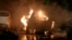 A vehicle is engulfed by flames at the site of a deadly explosion outside Karachi airport on October 6. 