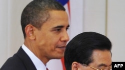 U.S. President Barack Obama walks with Chinese President Hu Jintao following a statement to the press in Beijing on November 17.