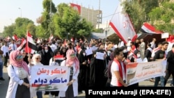 Students of Karbala University carry a banner reading in Arabic 'No nation, No permanence' as they take part in a protest and strike in Karbala, November 3, 2019