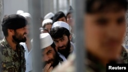 Prisoners stand in line for release during a ceremony handing over the Bagram prison to Afghan authorities at the U.S. air base north of Kabul in March 2013.