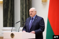 Belarusian ruler Aleksandr Lukashenka speaks in Minsk on June 27. He said Belarus does not need to fear the sudden Wagner presence in the country because his government "will keep a close eye on them."