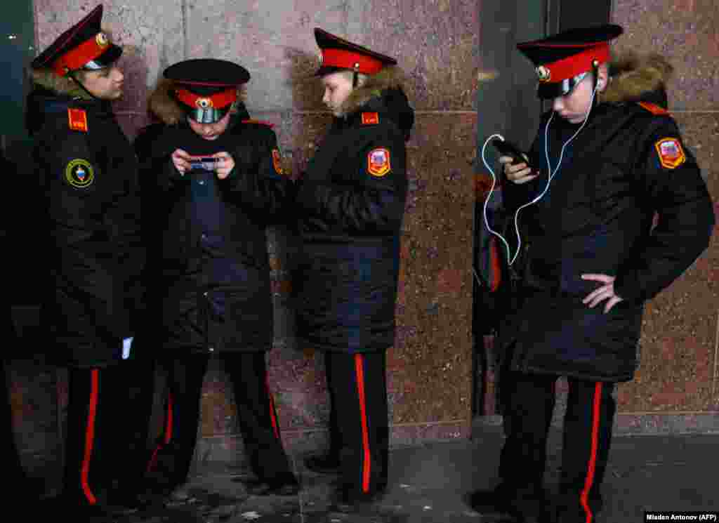 Russian cadets use their mobile phones during an annual get-together in Moscow. (AFP/Mladen Antonov)