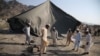 People survey the scene of a suicide bomb attack in Mohmand Dara district of Nangarhar Province on September 11.