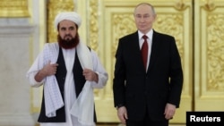 Afghanistan's ambassador to Russia, Gul Hassan Hassan, formally presents his official diplomatic papers to Russian President Vladimir Putin at the Grand Kremlin Palace in Moscow in January. In July 2025, Russia became the first country to formally recognize the Taliban government, and it remains the only one to have done so.