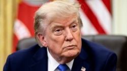 U.S. President Donald Trump signs executive orders at the Oval Office in Washington