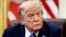 U.S. President Donald Trump signs executive orders at the Oval Office in Washington