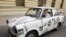 An East German Trabant decorated with reproductions of newspaper stories of the 1989 Pan-European Picnic arrives for the 20th anniversary of the gathering in Sopron.