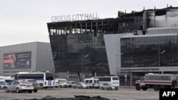 Police cars are parked outside of the Crocus City Hall in Moscow's northern suburb of Krasnogorsk on March 29, 2024, a week after a deadly attack by gunmen on the Moscow concert hall killed at least 143 people and wounded dozens more.