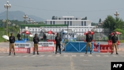 Security personnel stand guard in front of the Presidential Palace ahead of a Shanghai Cooperation Organization summit in Islamabad.