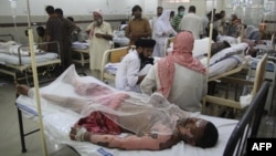 Burn victims injured in the tanker fire are treated at a hospital in Bahawalpur on June 25.