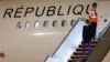 French President Emmanuel Macron disembarks from his plane as he arrives in Baghdad to attend a summit of Middle East leaders.