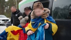 Ukrainian children returning home in February after being held in Russia. 
