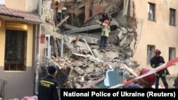 Members of Ukraine's emergency services work at the site of a gas explosion in the town of Drohobych in the Lviv region on August 28. 