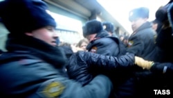 Russian police try to separate gay-rights activists and supporters of a new law against disseminating "homosexual propaganda" to minors outside the State Duma in Moscow. The bill is one considered by Human Rights Watch to be of "an absolutely regressive and repressive nature" passed recently.