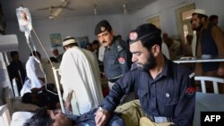 Police officers tend to their injured colleagues at a hospital following an attack in Khyber Pakhtunkhwa.