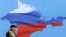 Ukraine -- A man walks past a poster depicting Crimea in the colors of the Russian flag, in Sevastopol, March 11, 2014