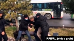 Plainclothes security officers detain protesters during demonstrations over fuel prices in Shymkent in early January.