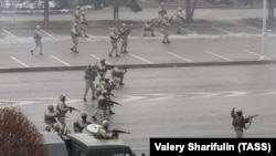 Security forces are seen being sued against anti-government protests in Almaty on January 6.