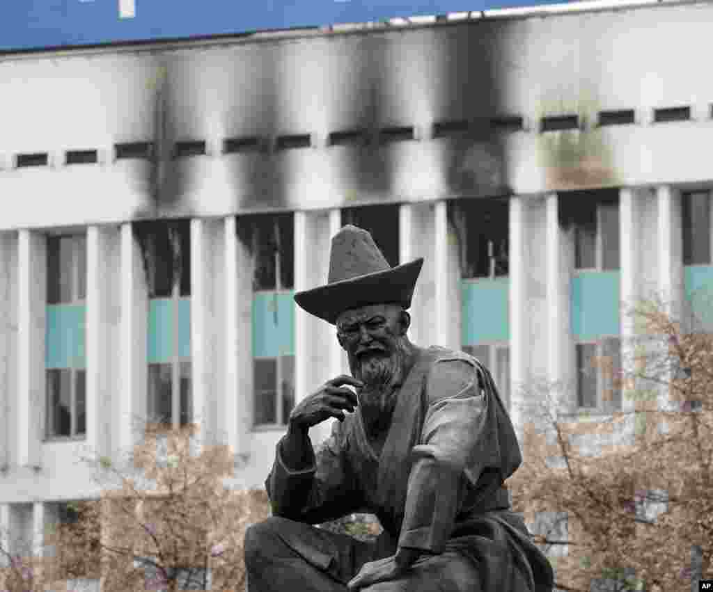 A fire-damaged building and sculpture on Almaty&#39;s central square on January 11.&nbsp;