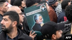 Demonstrators in Baghdad mark the anniversary of the attack that killed Iranian General Qassem Soleimani. 
