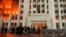 Protesters are seen on January 5 outside the Almaty mayor’s office, which was set ablaze during the protests.