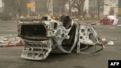 A burned-out cars lies upside down on a square in central Almaty following violence in Kazakhstan's largest city on January 6.