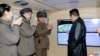 An official North Korean photo shows the country's leader Kim Jong Un (right) speaking with military officials during what state media said was a hypersonic missile test on January 11. 