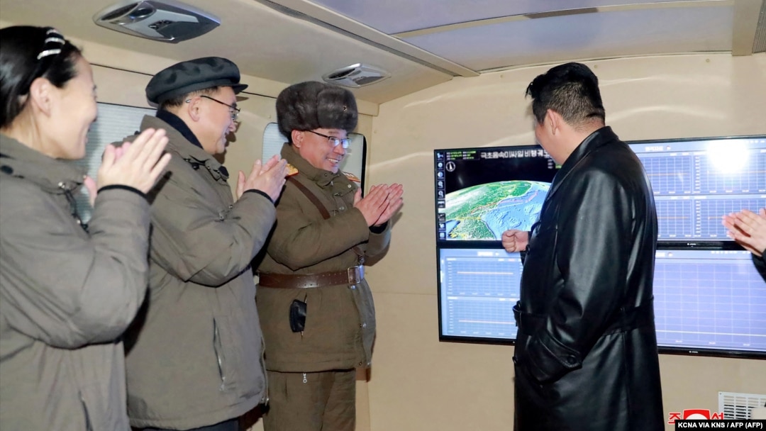 An official North Korean photo shows the country's leader Kim Jong Un (right) speaking with military officials during what state media said was a hypersonic missile test on January 11. 