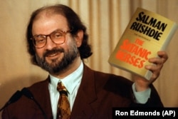 Rushdie, kezében az Iránban betiltott Sátáni versekkel egy 1992-es arlingtoni sajtótájékoztatón