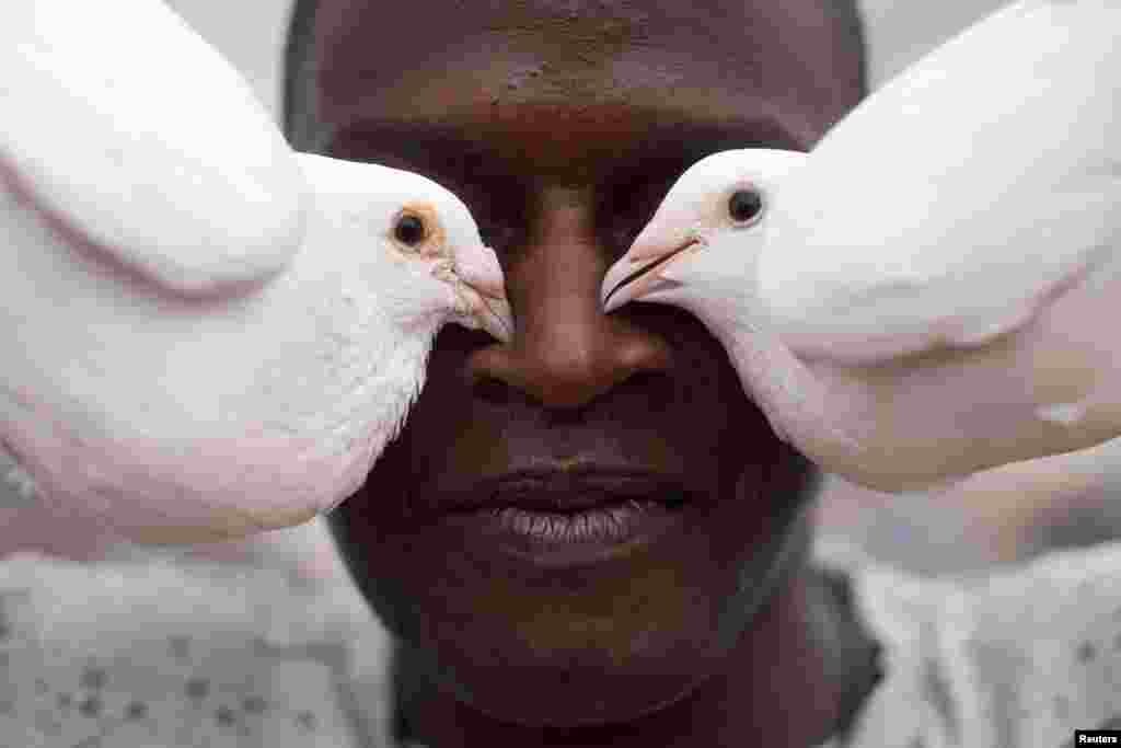 Pigeon fancier Yonisbel Santana poses for a photo at his rooftop in Havana, Cuba, May 18, 2021. Picture taken on May 18, 2021