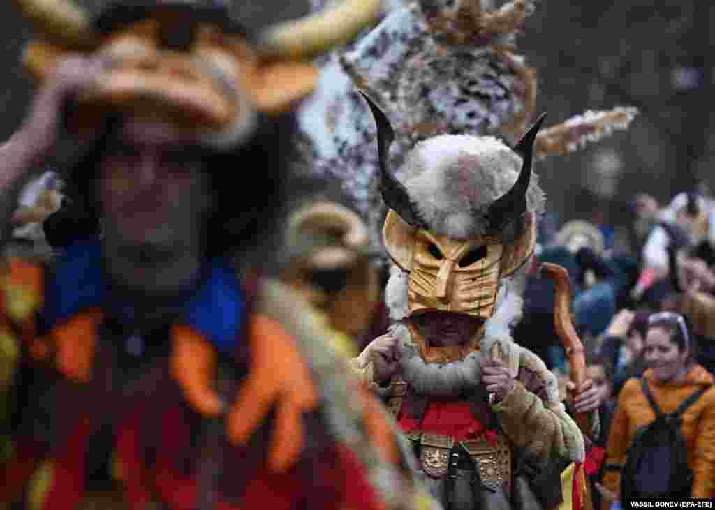 Masked dancers called kukeri perform a traditional dance during the Surva Festival to ward off evil spirits in Sofia, Bulgaria.
