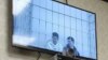 Salekh Magamadov and Ismail Isayev are seen on a video monitor in a courtroom in Achkhoi-Martan.