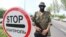 A pro-Russian militant stands guard at a checkpoint on the road from Donetsk to Mariupol.