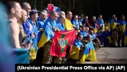 Ukrainians pose for a photo after being released in a prisoner exchange at an undisclosed location in Ukraine on September 14.